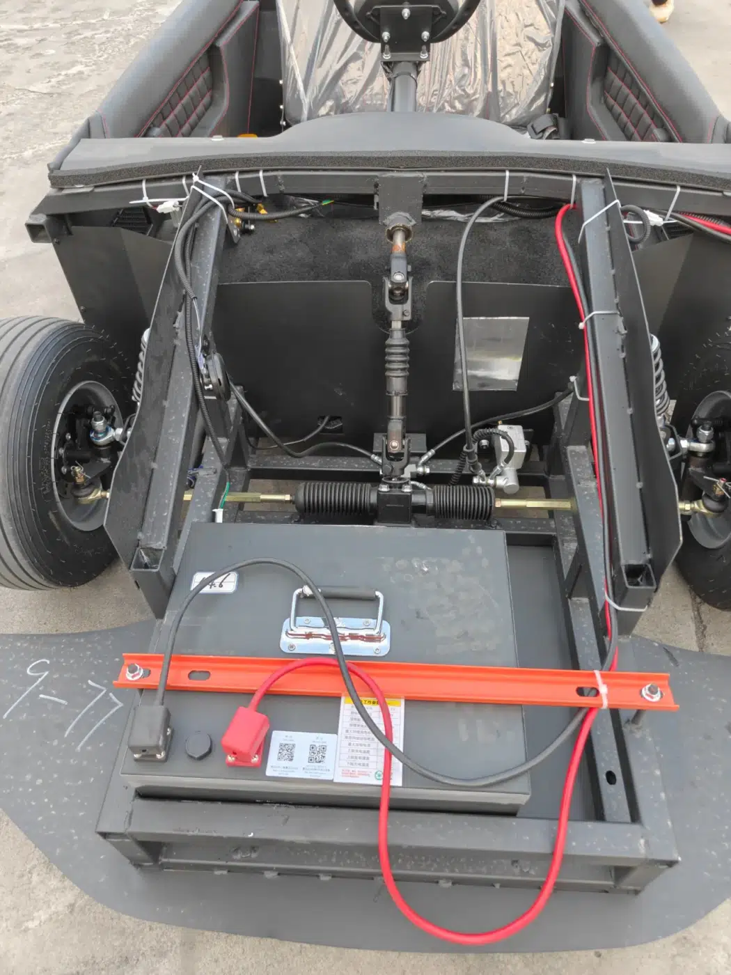 Front-mounted battery compartment component photograph for electric go-karts; exact model compatibility to be confirmed